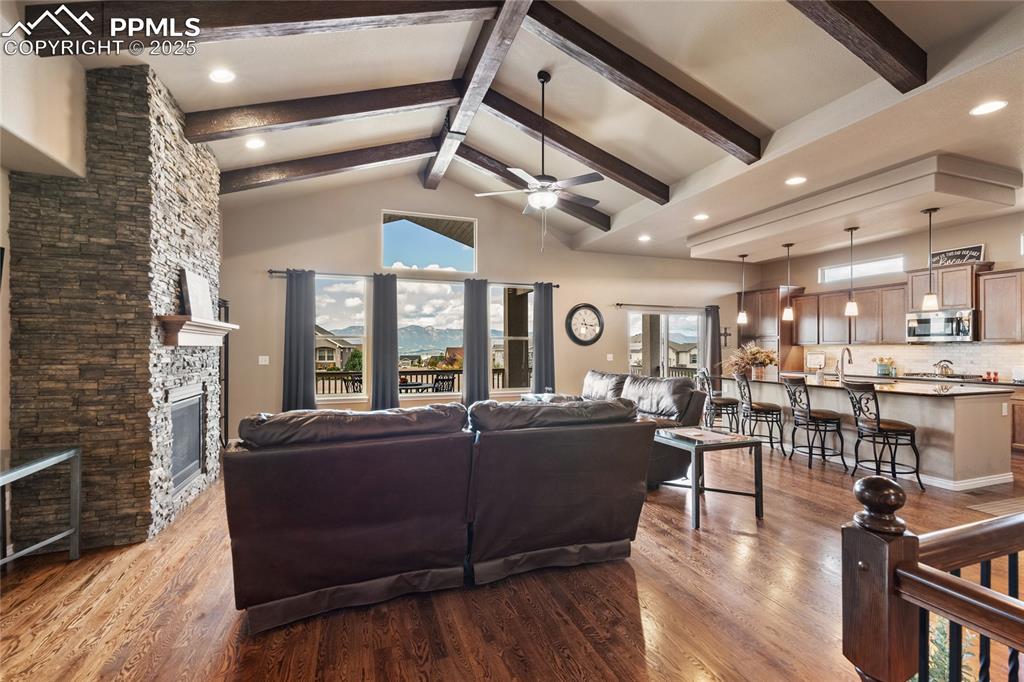 Vaulted ceiling with accent beams and a gas fireplace. 