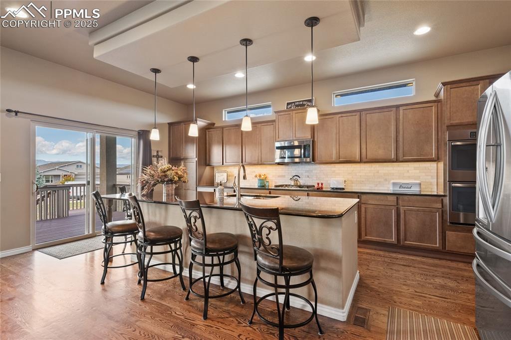 Large island for extra seating with walkout to the covered deck. 