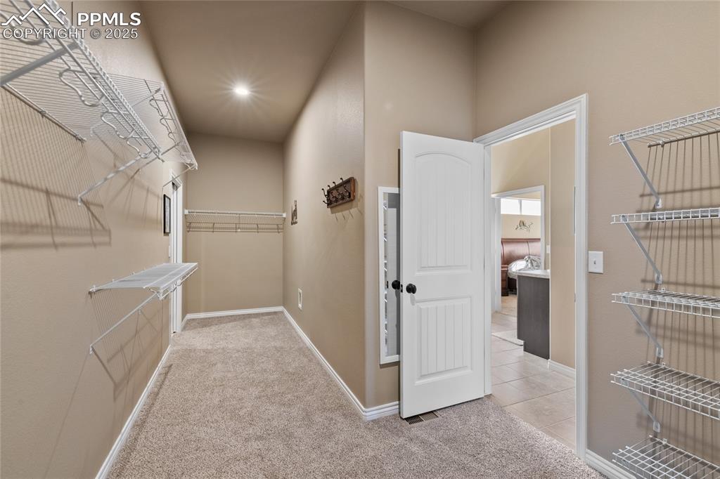 Huge walk-through closet from primary bath into the laundry room. 