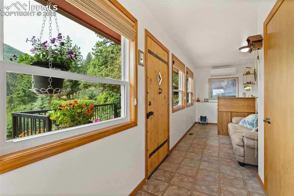 Enclosed Patio with a Knotty Wood Custom Solid Entrance Door and Tile Flooring!