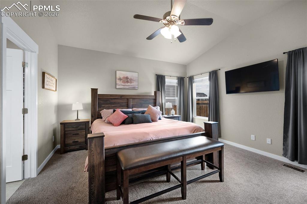 Bedroom with high ceilings, and ceiling fan
