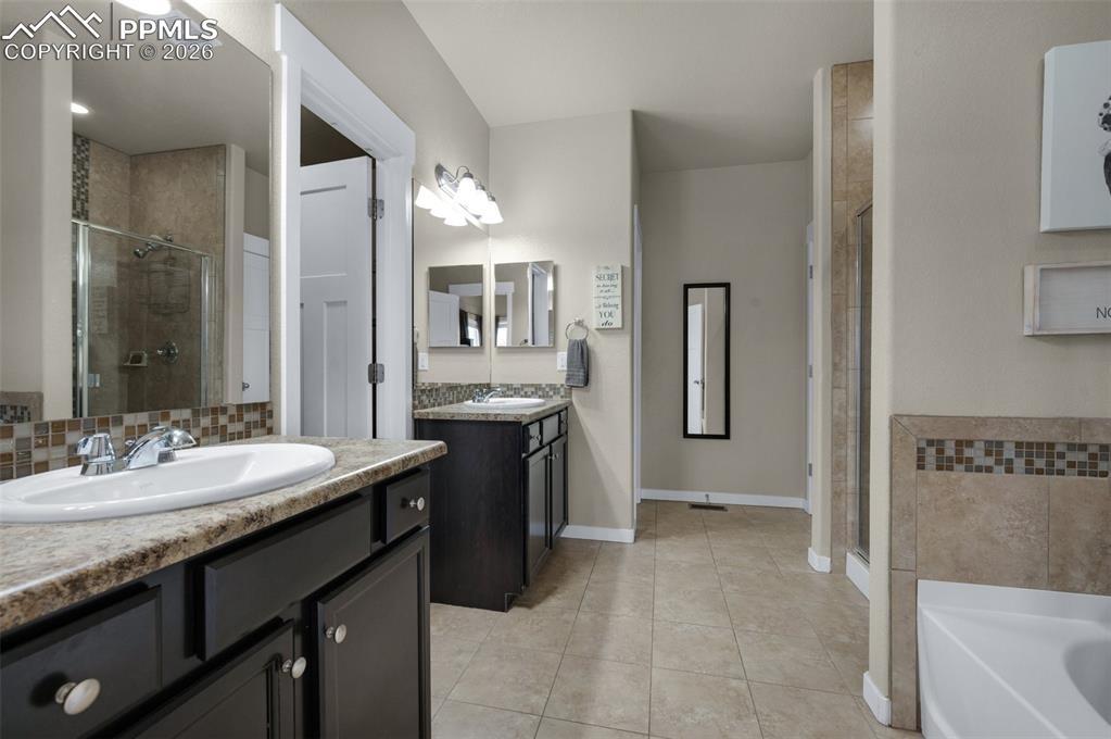 Double vanities, tile flooring, large walk-in closet