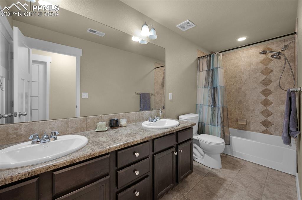 Basement bathroom, with doiuble vanity, and tile flooring