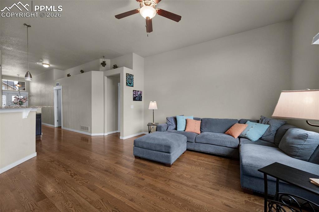 Living area with ceiling fan, oak hardwood flooring