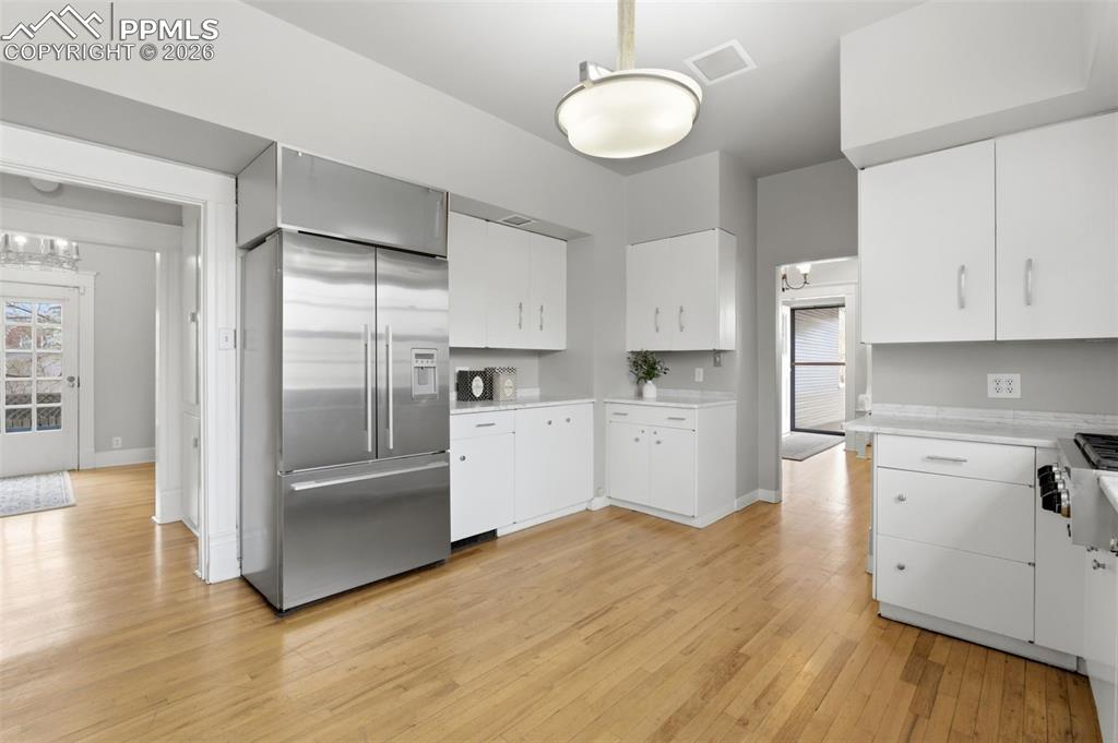 Kitchen with Carrara Marble Tile and Hardwood Floors