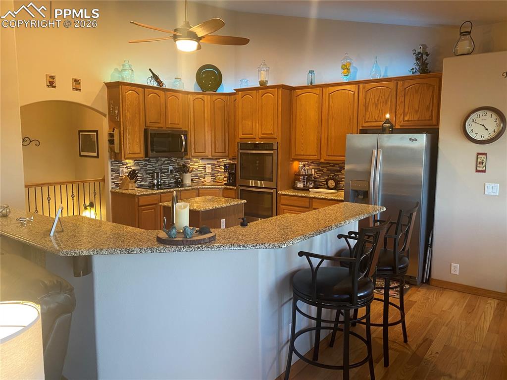 The modern kitchen features granite countertops and stainless steel appliances, perfect for gourmet cooking and stylish entertaining