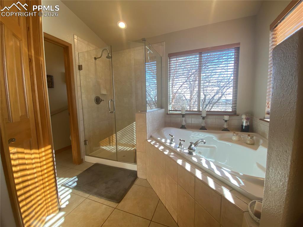 With a jetted soaking tub & free standing shower