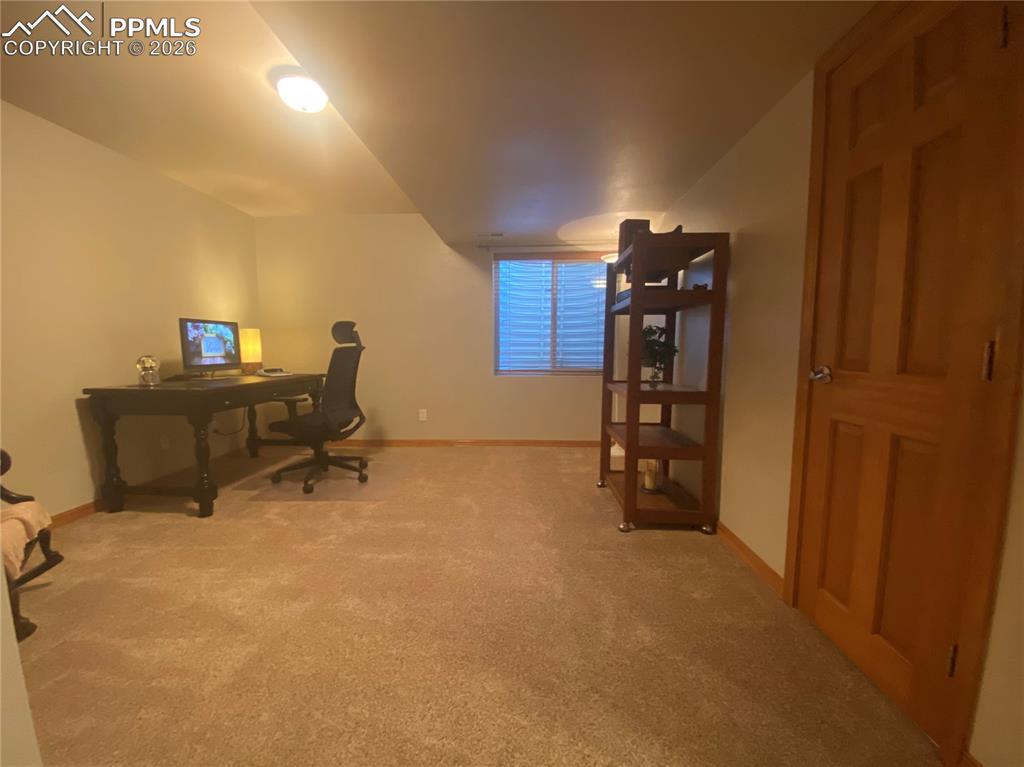 Basement bedroom with adjacent full bathroom, offering convenient access, added privacy, and flexible living space in the finished lower level