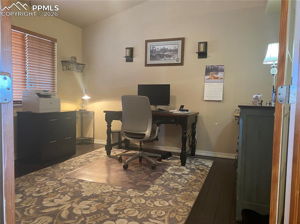 This functional home office, thoughtfully converted from a formal dining room, offers flexible living space for remote work, study, or a private workspace.