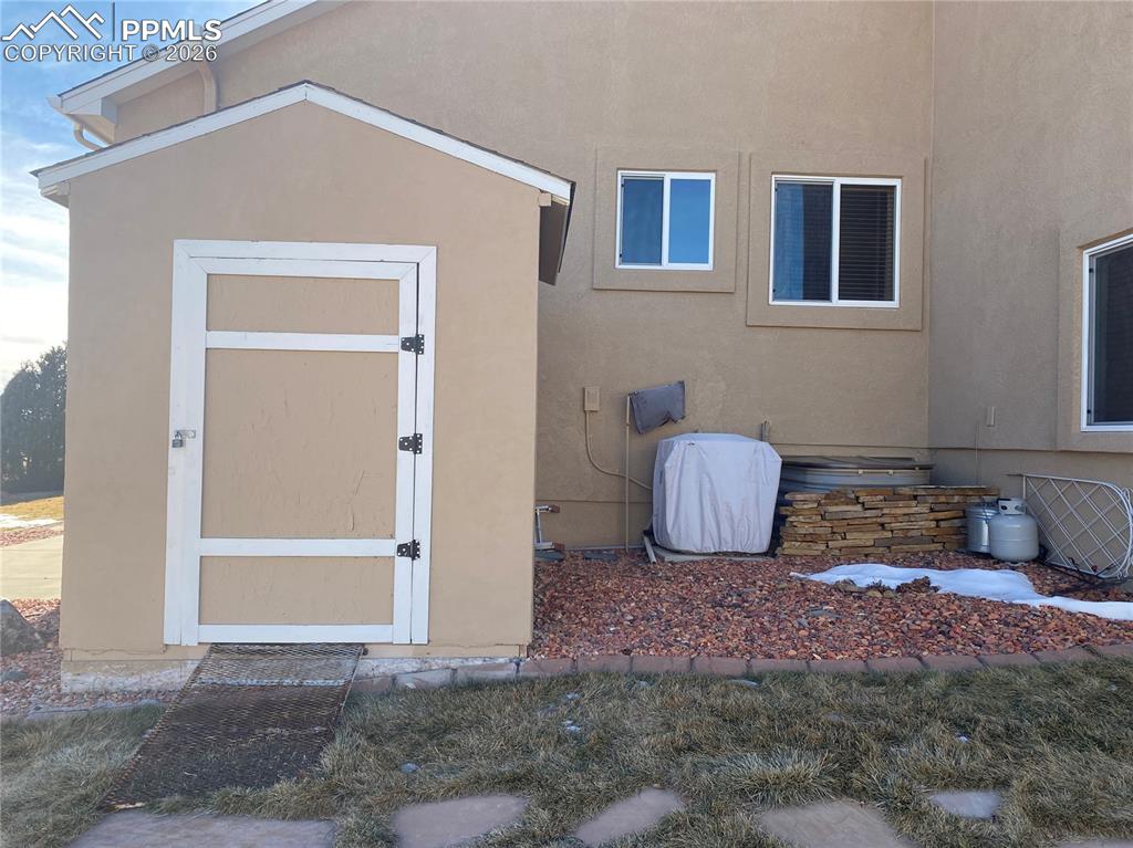 A shed with matching stucco is great for outdoor storage