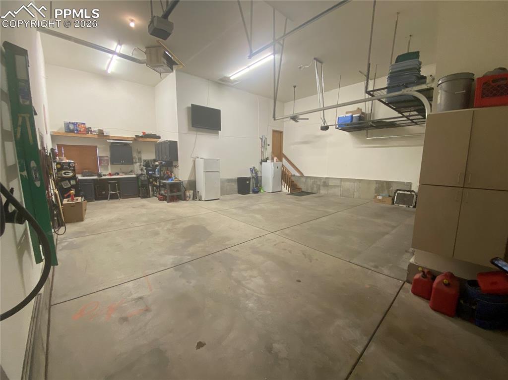 The oversized 4-car heated RV garage offers ample storage, workshop space, and parking for RVs, boats, or multiple vehicles—truly a must-see feature