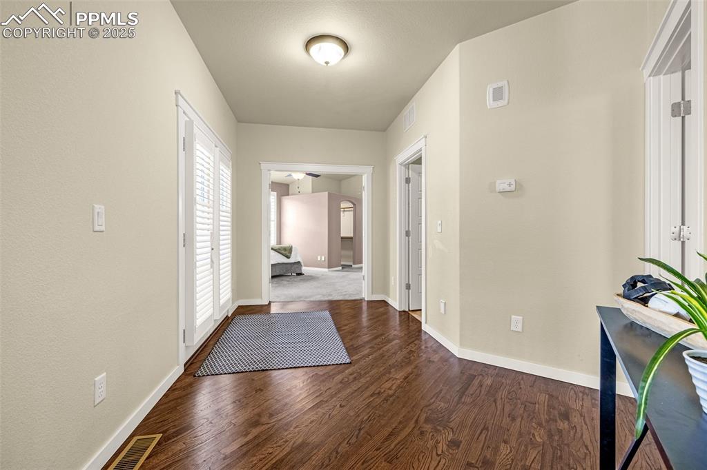 Hall featuring dark hardwood flooring