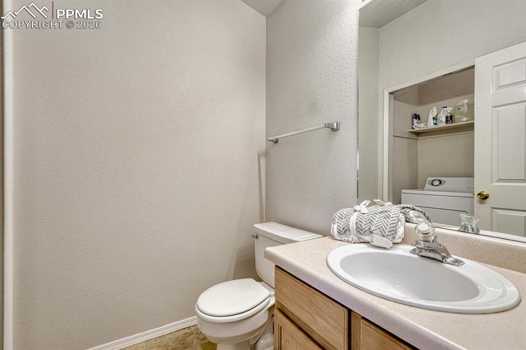 Main level power room with attached laundry area