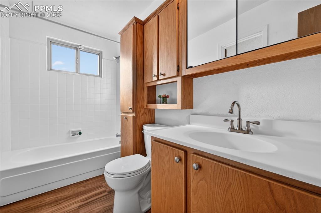 Primary bathroom features new LVP flooring and tons of storage space