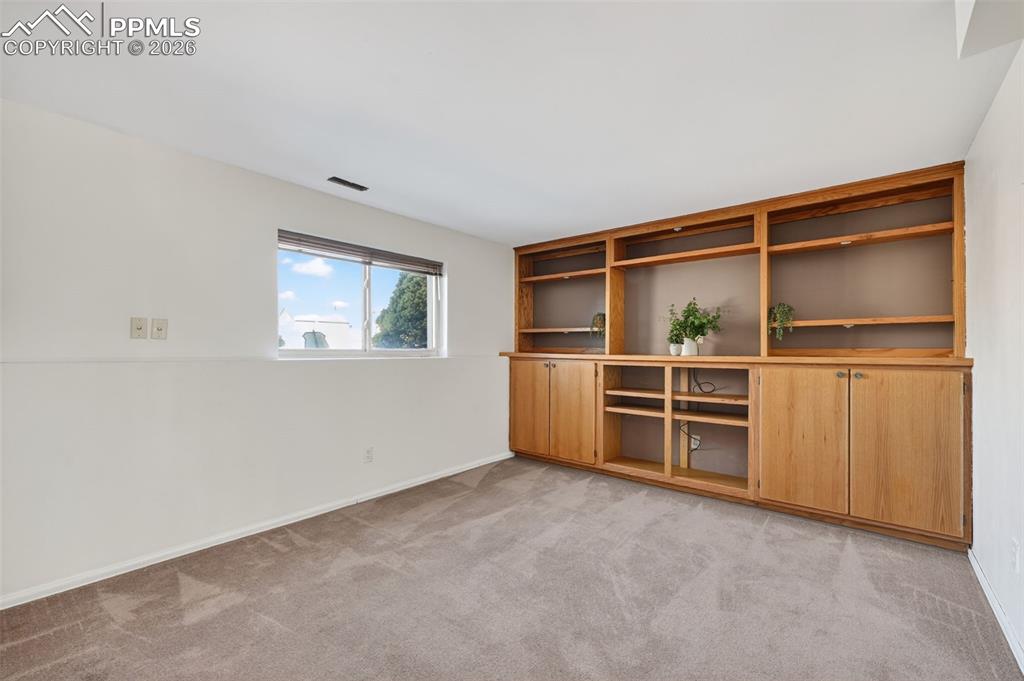Retreat to the family room entertainment oasis with beautiful oak built-ins