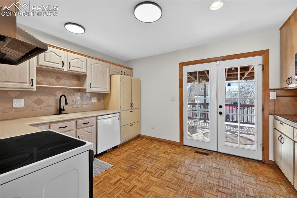 Kitchen features ample cabinet and counter space and walks out to the covered deck