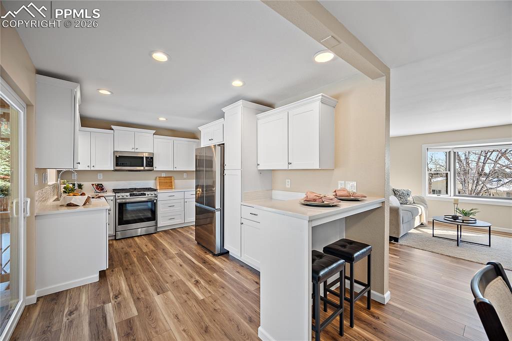 Fully updated kitchen with quartz countertops, new white cabinetry, SS, gas range/oven