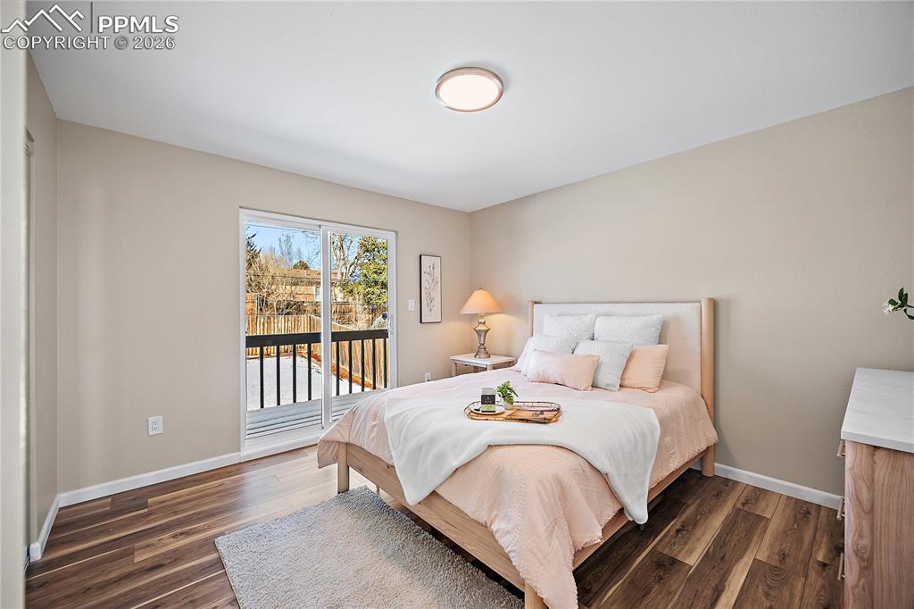 Primary bedroom with walk out to private deck. New flooring paint and lighting. 