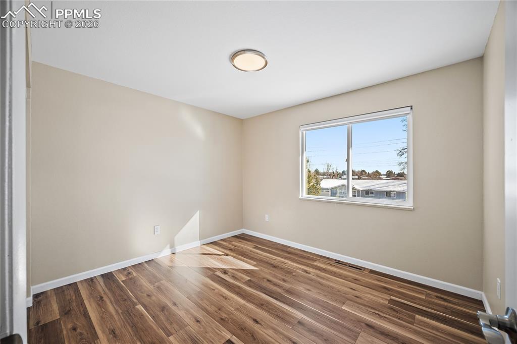 Upstairs bedroom 2 new flooring, paint and lighting. 