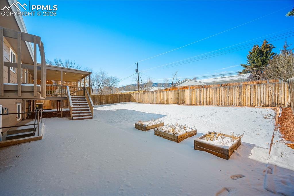 Large concrete patio, raised garden beds. 