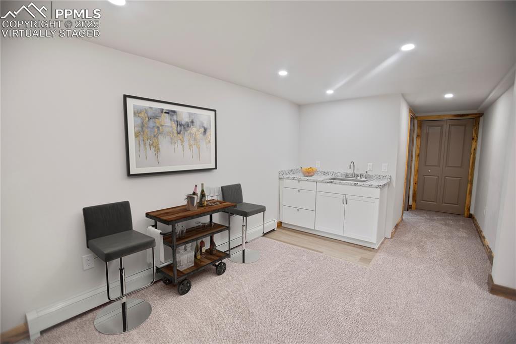 Lower level family with wet bar  - Virtually Staged