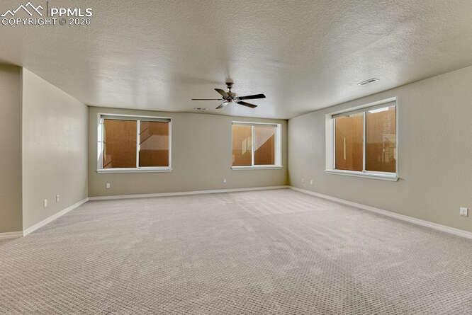 Huge Basement Family room with large windows and fan