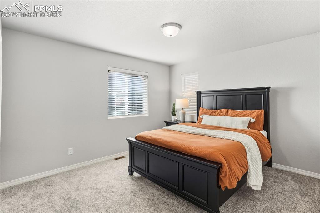 Bedroom featuring light colored carpet