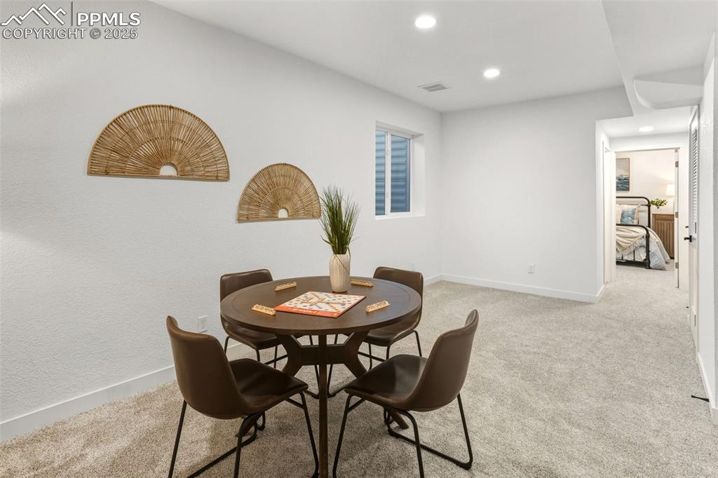 Dining space featuring light carpet and recessed lighting