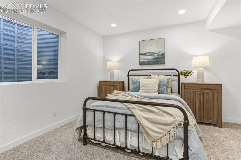 Bedroom featuring light carpet and recessed lighting
