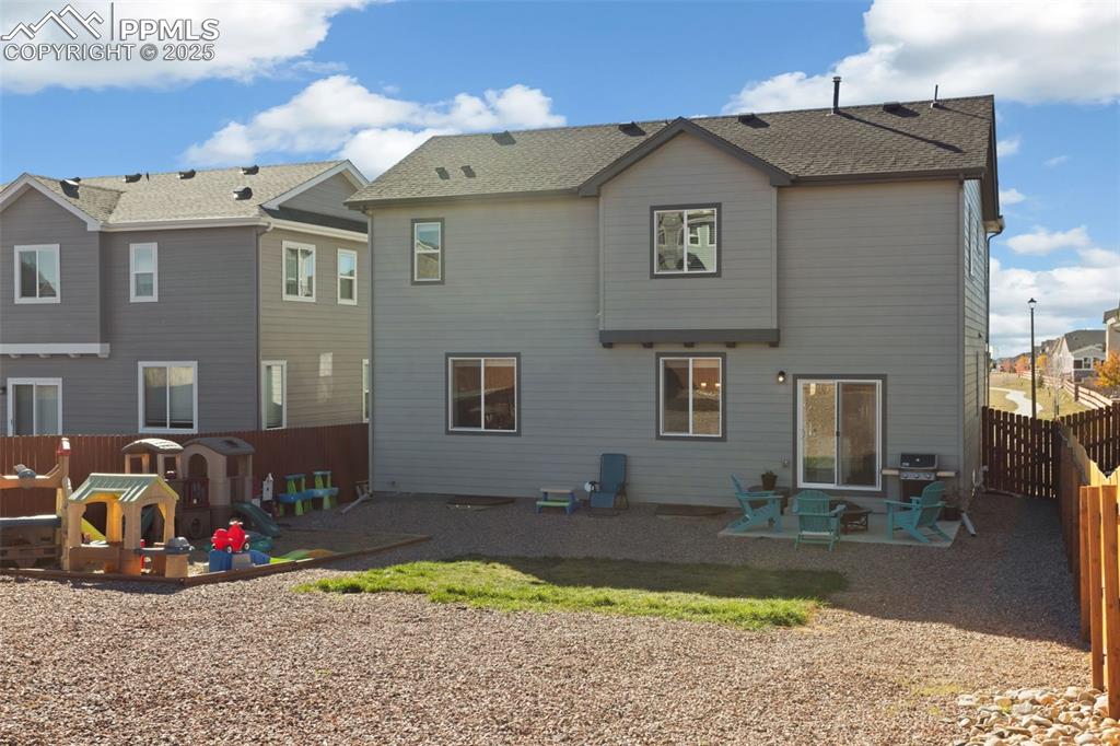 Back of house featuring a patio area, a fenced backyard, and a residential view