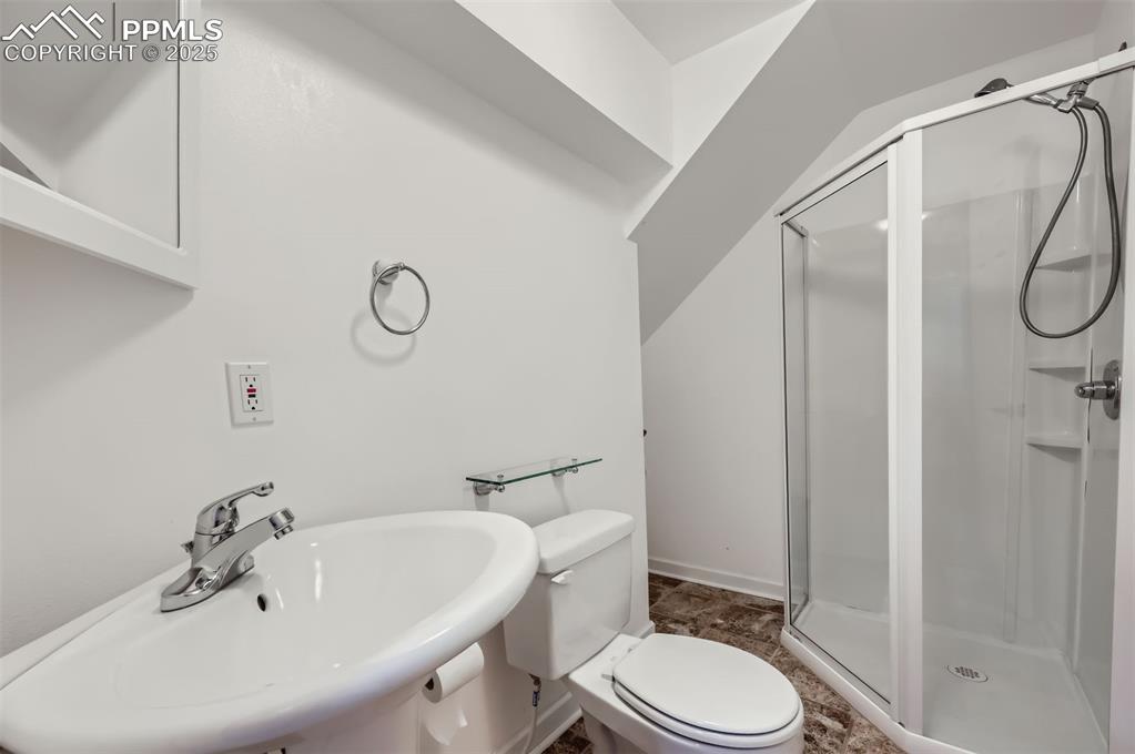 3/4 bathroom featuring a sink and a shower stall