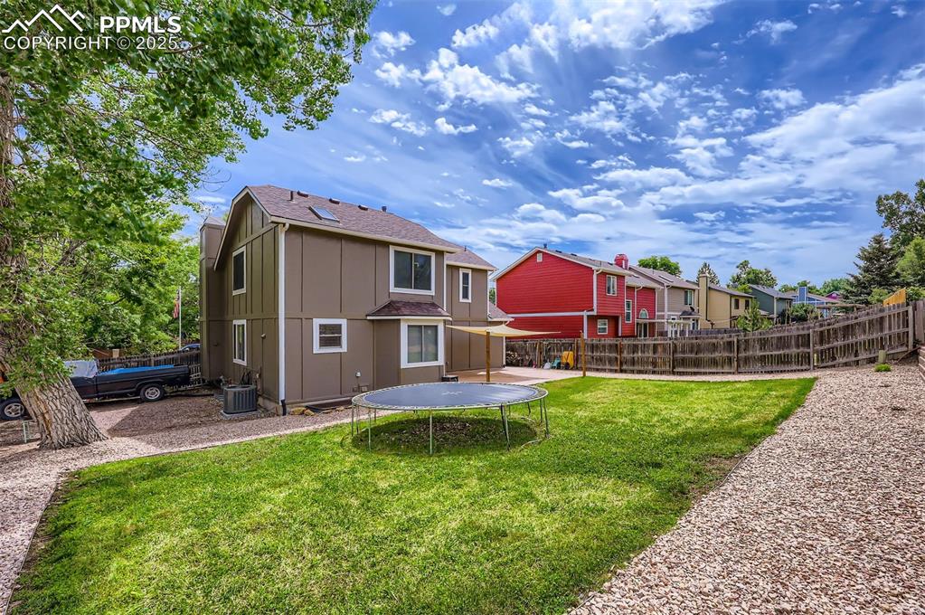 Back of house with a double gate for small RV, boat, or car storage