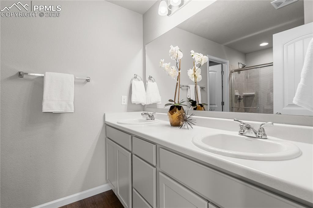 The primary bathroom is stunning with solid surface countertops, a free standing shower, and dual sinks.