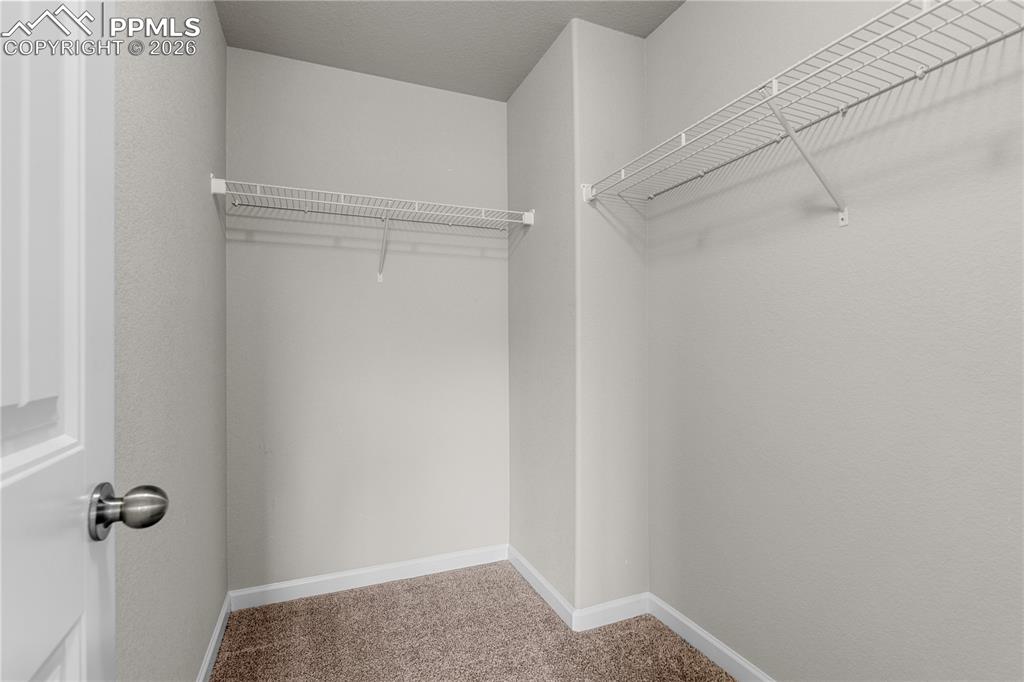 The bedroom has a walk in closet for storage.