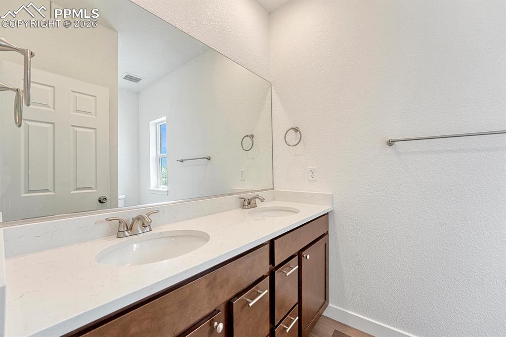 En suite primary bathroom offers double vanity with undermount sinks. Pick your cabinetry, stone countertop, flooring and paint to suite your style.