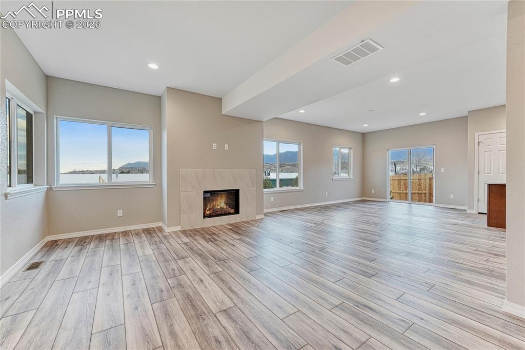 Open living area with gas fireplace and tile surround designed by you!