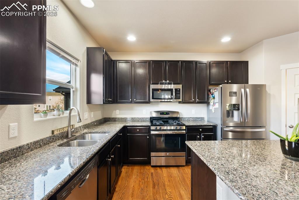 Kitchen with granite countertops and stainless appliances.