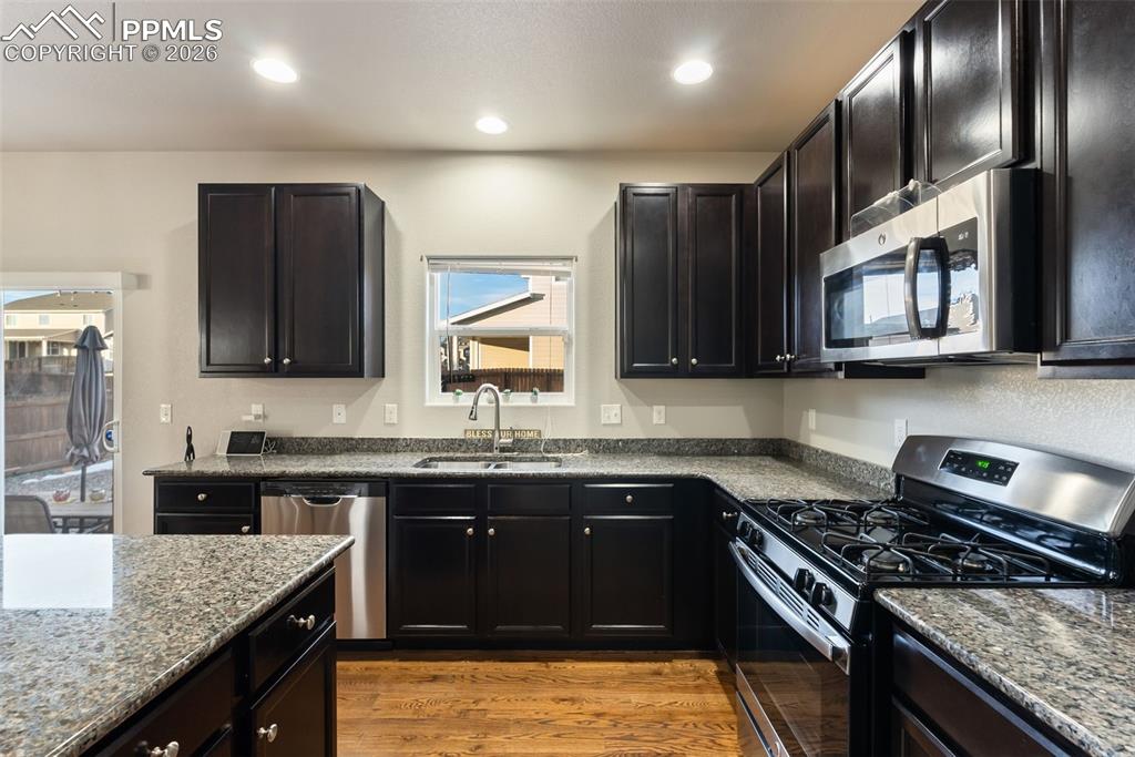Alternate view of the kitchen with granite countertops.