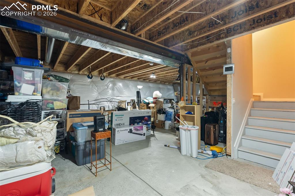 Unfinished basement with full-height ceilings and room to expand.
