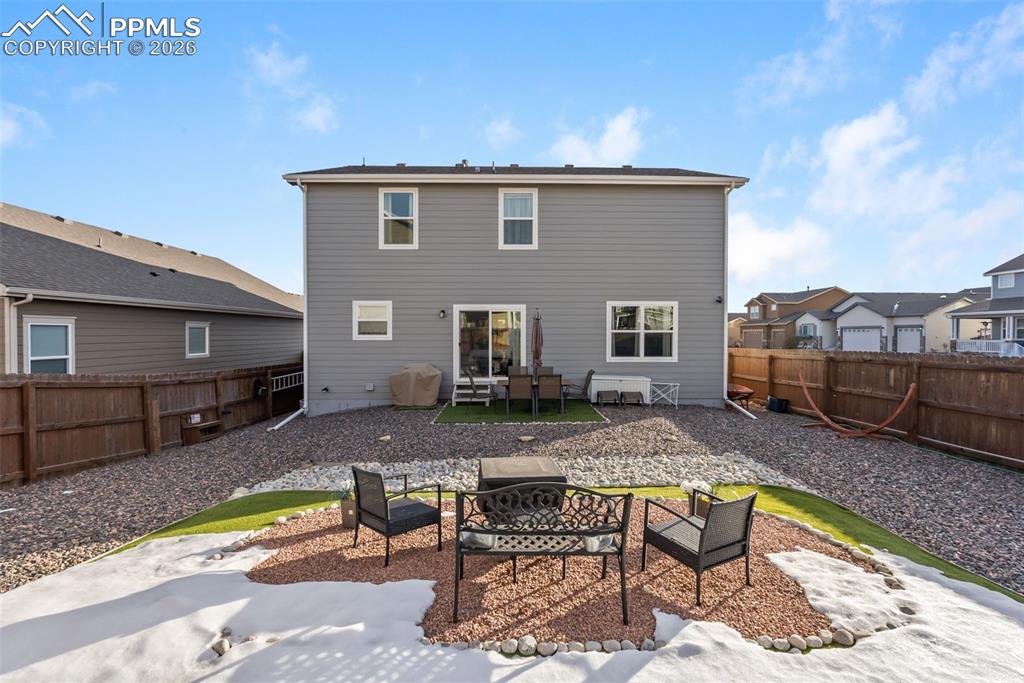 Rear exterior with large fully fenced yard.