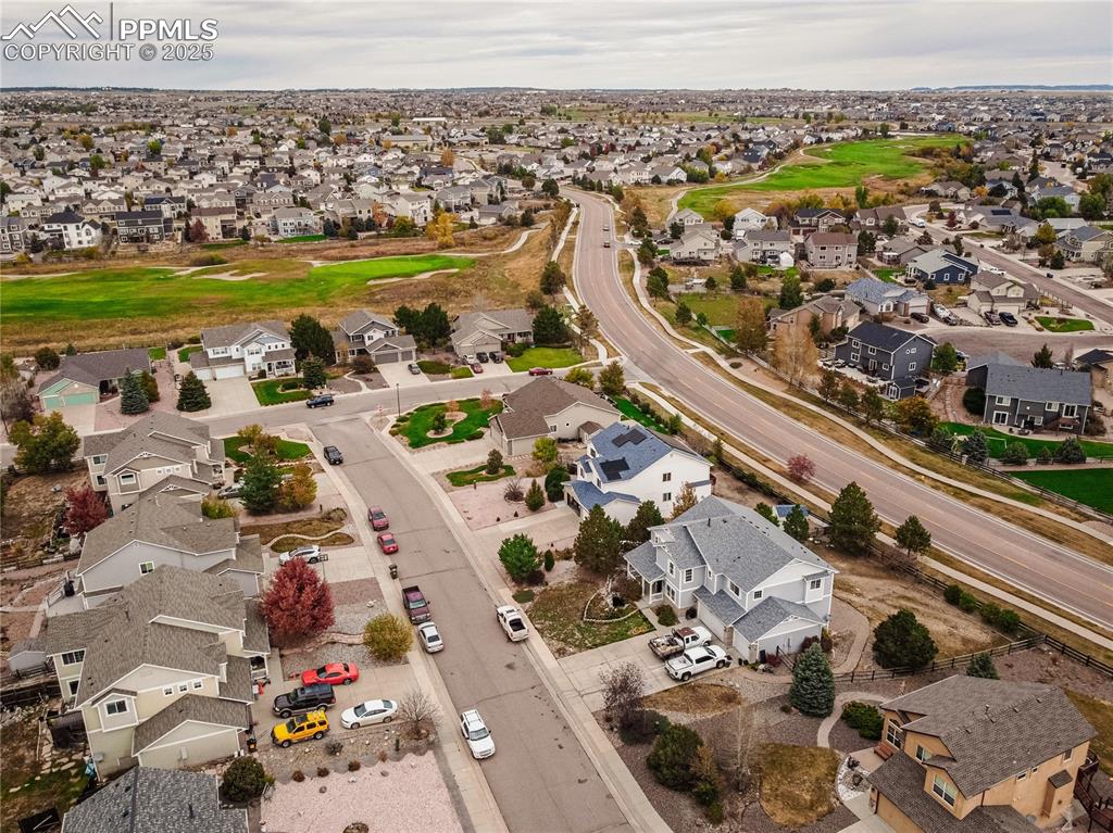 Aerial view of residential area featuring a golf course
