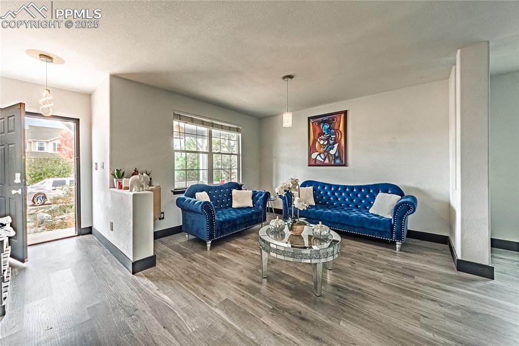 Living room featuring wood finished floors and a textured ceiling