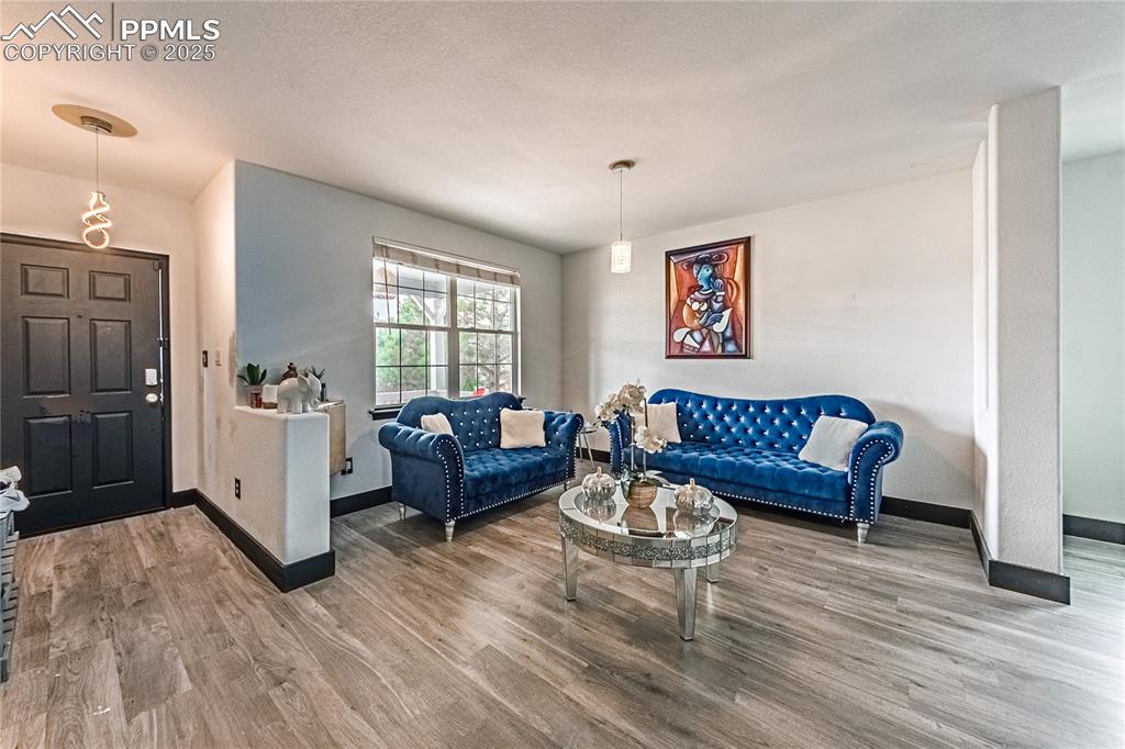 Living room featuring light wood-style floors and baseboards