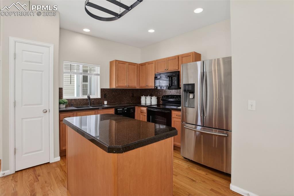 Mosaic tiled backsplash, Italian glass granite overlay countertops, pantry, ample cabinets, pot rack and center island!