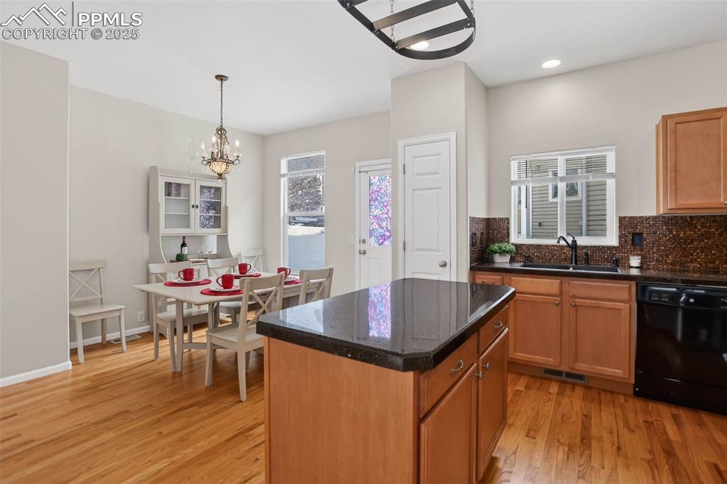 Mosaic tiled backsplash, Italian glass granite overlay countertops, pantry, ample cabinets, pot rack and center island!