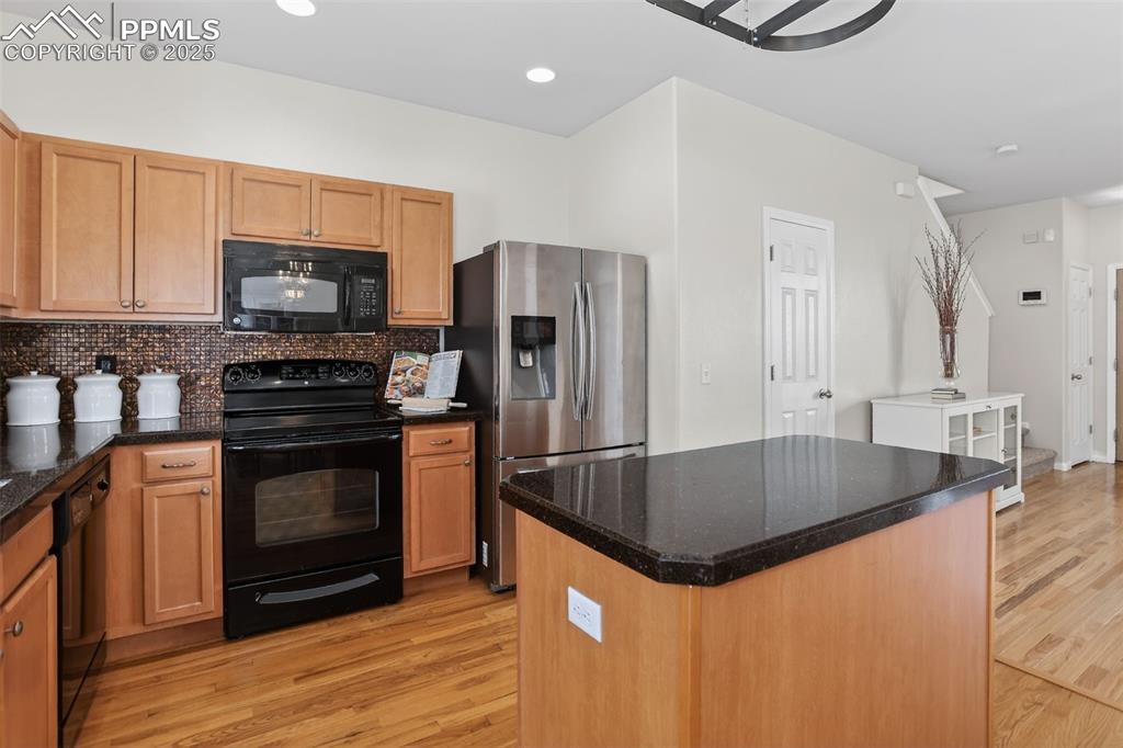 Mosaic tiled backsplash, Italian glass granite overlay countertops, pantry, ample cabinets, pot rack and center island!