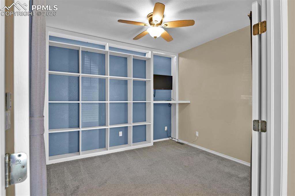Office on the main level with French doors and built-in shelves