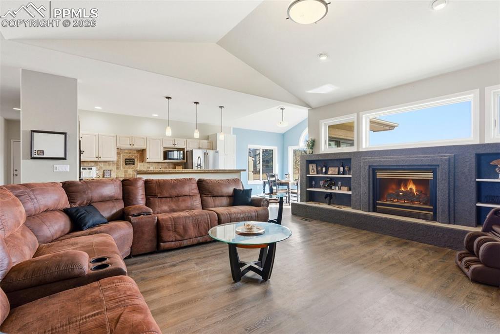 Living area with a fireplace, and built in shelving
