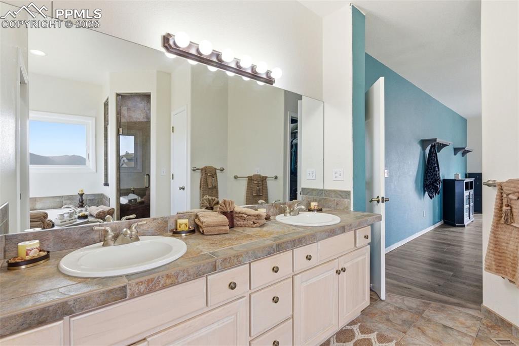 Ensuite 5 piece bath featuring a jetted tub and double vanity and separate shower