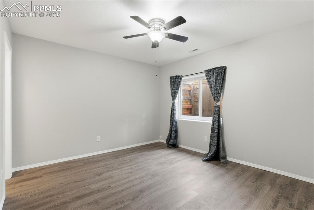 Bedroom with walk in closet and a ceiling fan